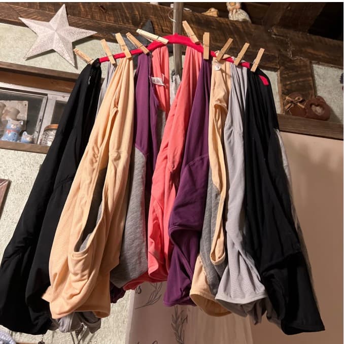 Ad creative: nine pairs of underwear in assorted colors clipped with clothespins to a red hanger in a rustic home