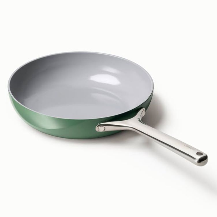 Single sage-green Caraway ceramic fry pan with a stainless handle on a white background