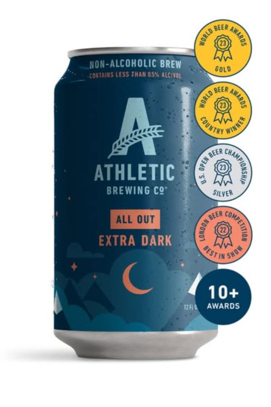 Athletic Brewing All Out Extra Dark can beside a column of beer-competition award medallions and a “10+ Awards” badge