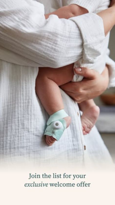 Parent in white linen holding a baby wearing a mint Owlet sock, with the line “Join the list for your exclusive welcome offer”