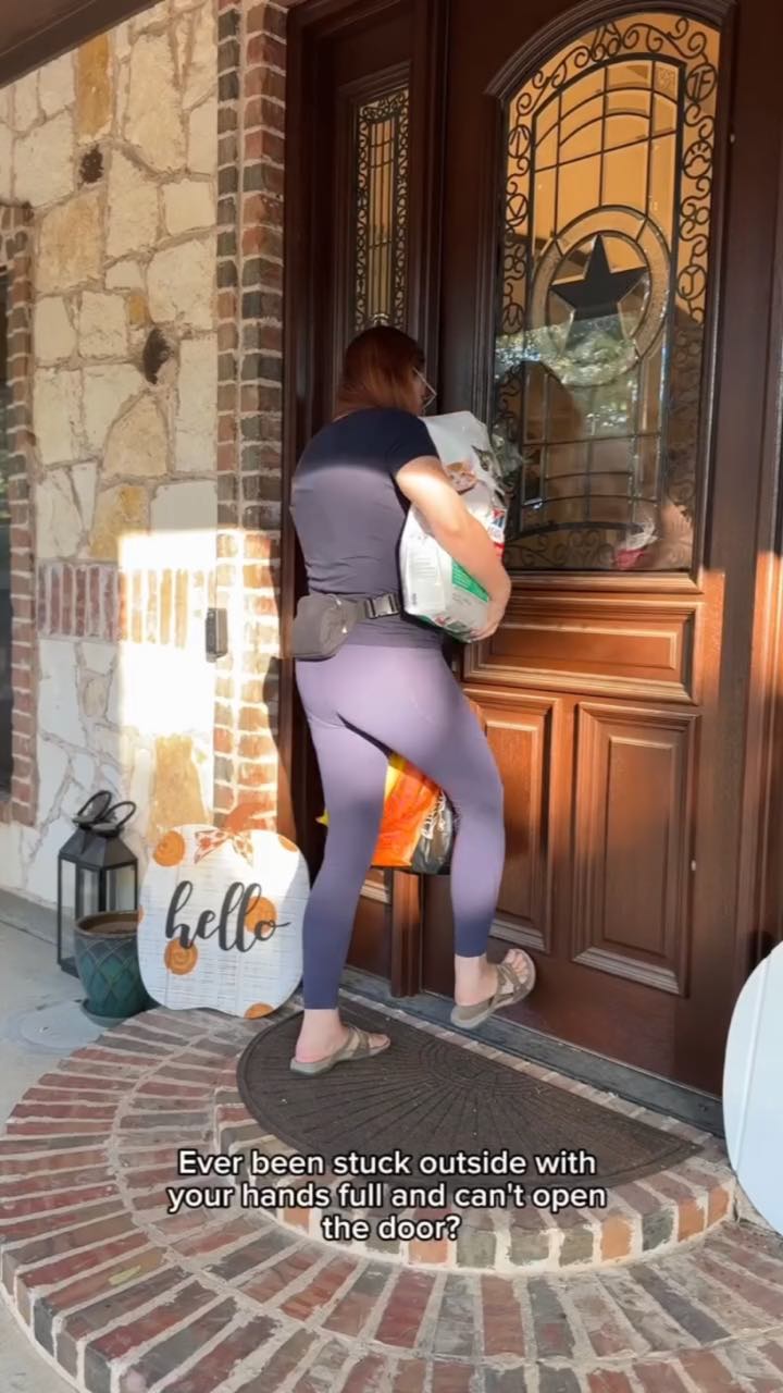 A woman with a pet-food bag and shopping bags in her arms nudges at her front door, captioned “Ever been stuck outside with your hands full and can't open the door?”