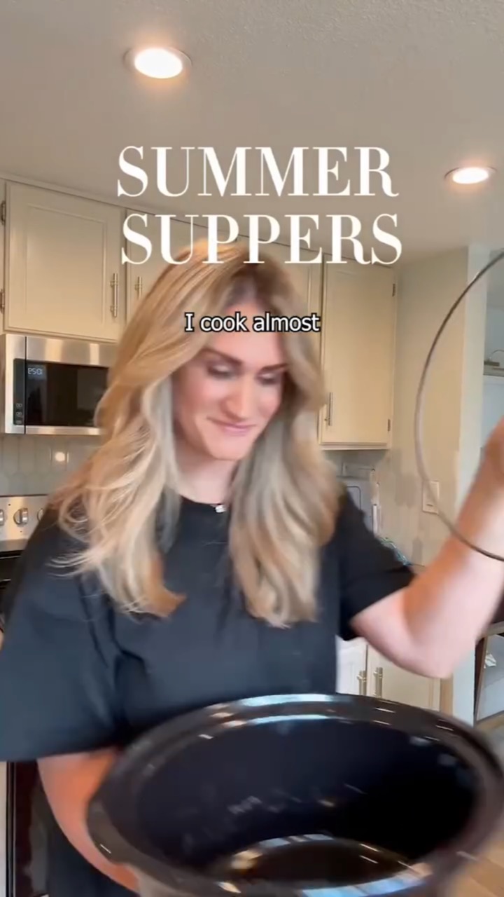 A smiling blonde creator lifts the lid off a slow cooker in her kitchen under a serif “SUMMER SUPPERS” title, subtitled “I cook almost”